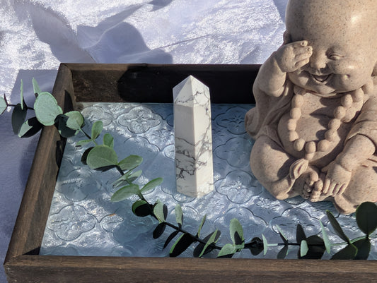 Howlite tower crystal on vintage tray with buddha