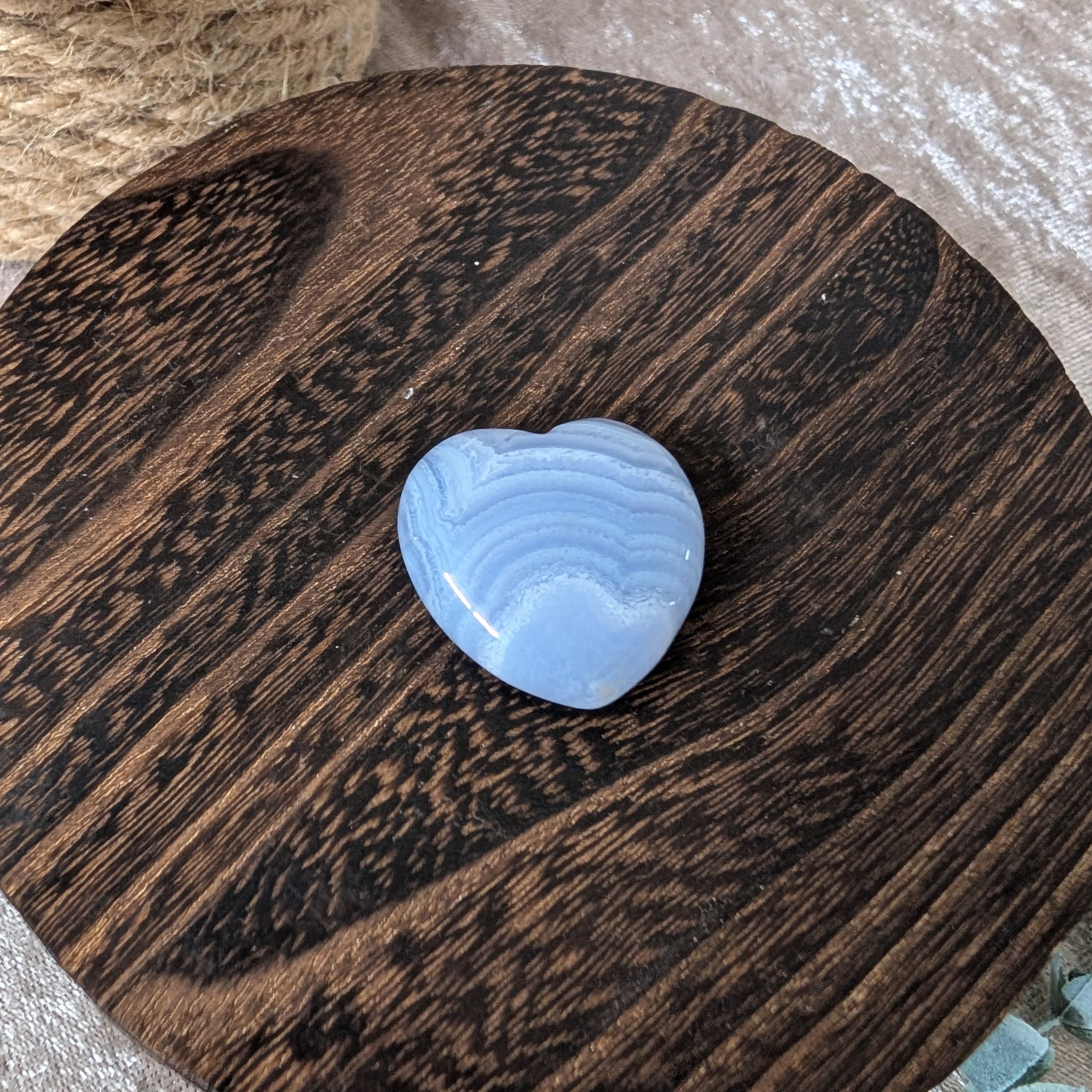 Rare beautifully banded blue lace agate heart set on vintage style wooden boho decor