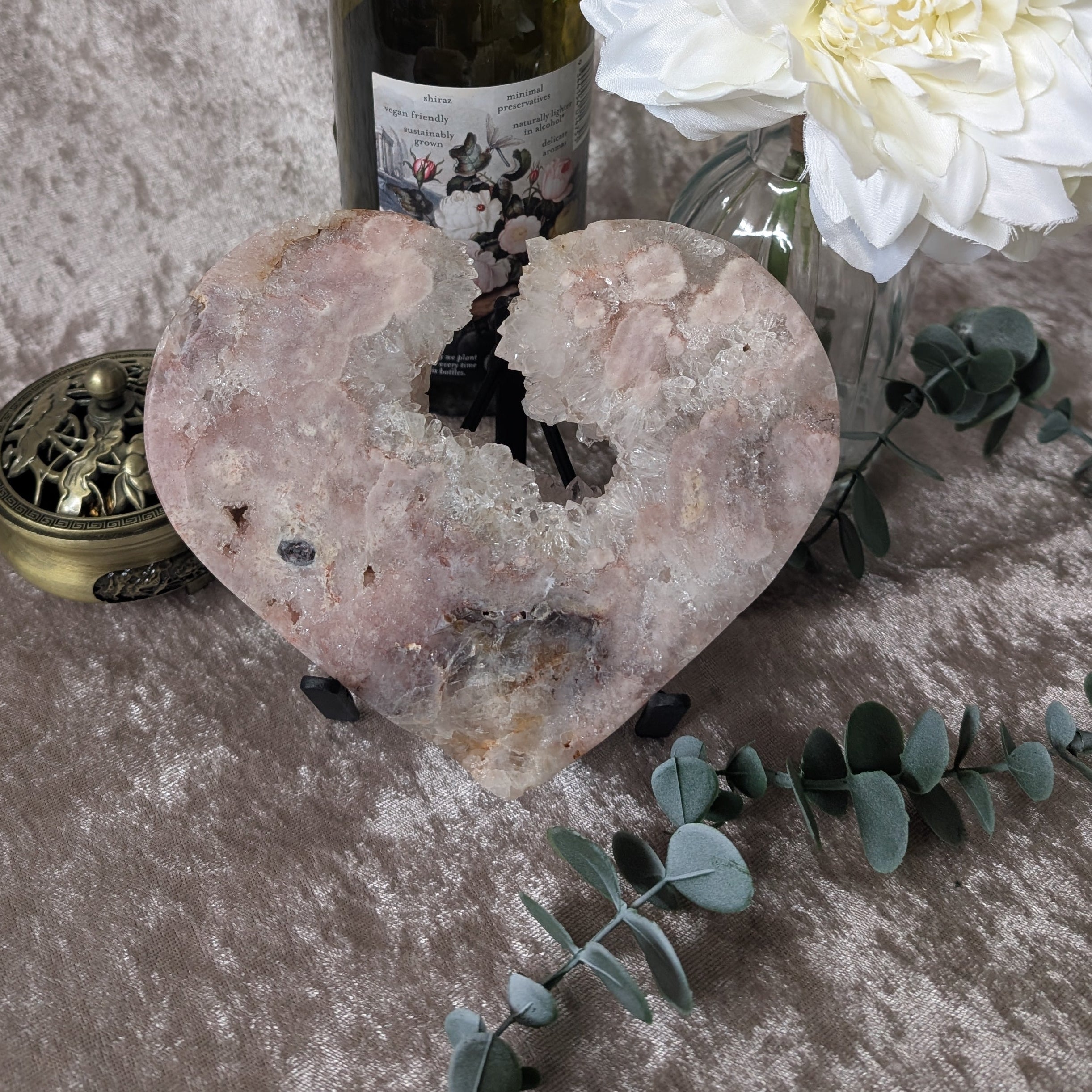 Pink amethyst heart crystal viewed from the side highlighting natural inclusions