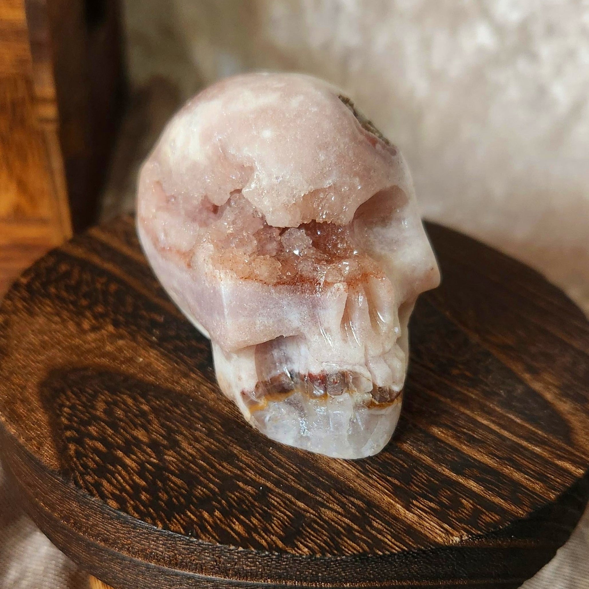 Pink amethyst skull crystal featuring natural druzy pockets