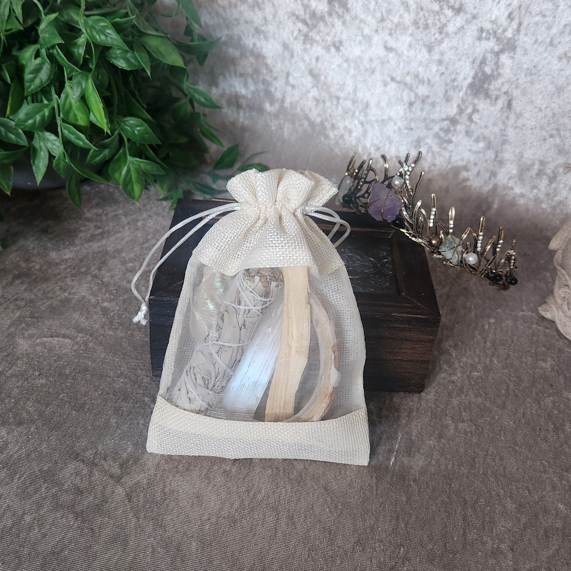 Crystal protection kit contents displayed, including cleansing herbs and grounding stones