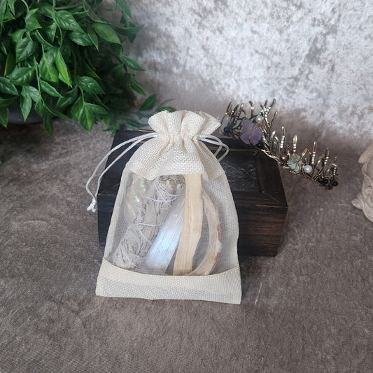 Crystal protection kit contents displayed, including cleansing herbs and grounding stones
