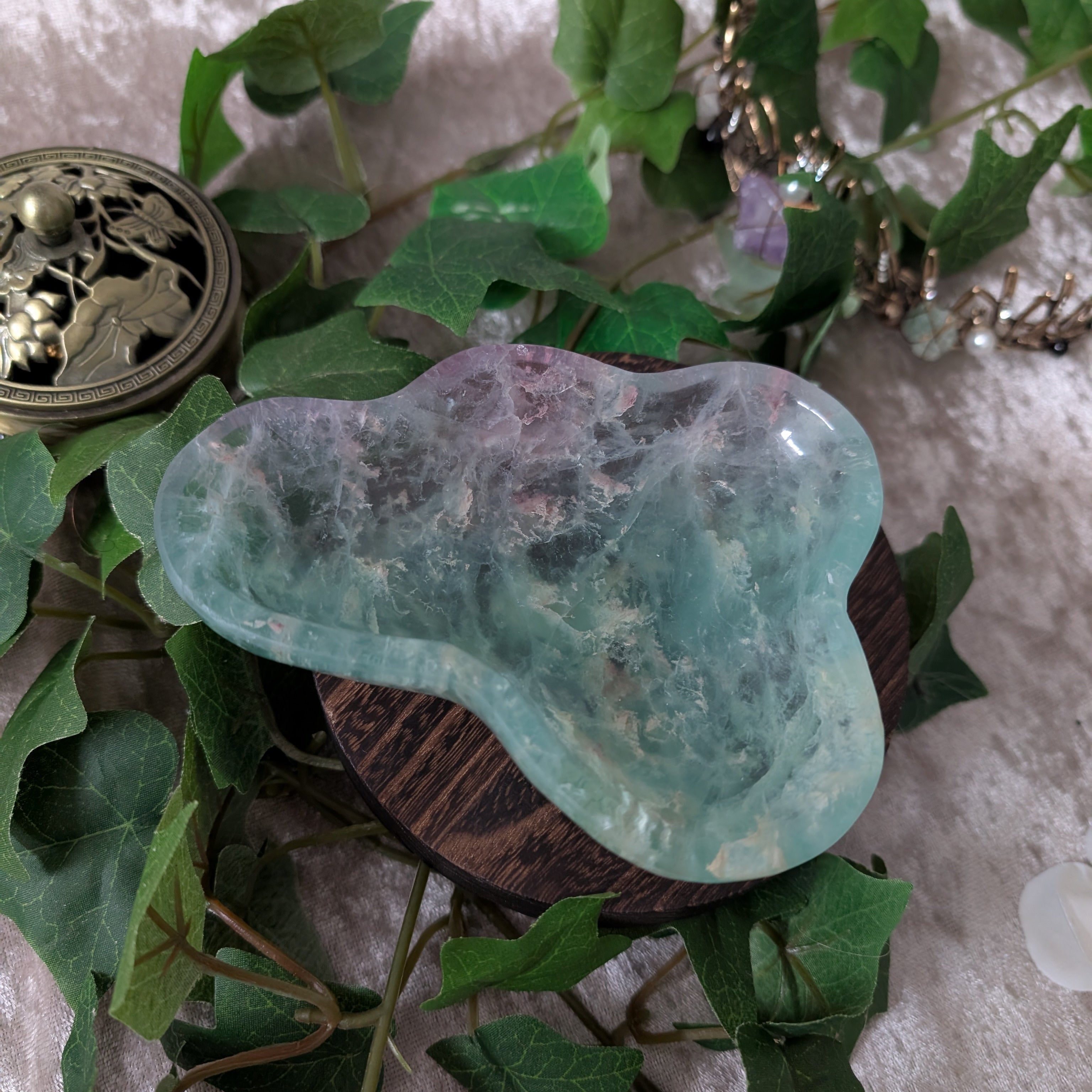 Rainbow Fluorite Bowl set in boho style decor setting surrounded by ivy
