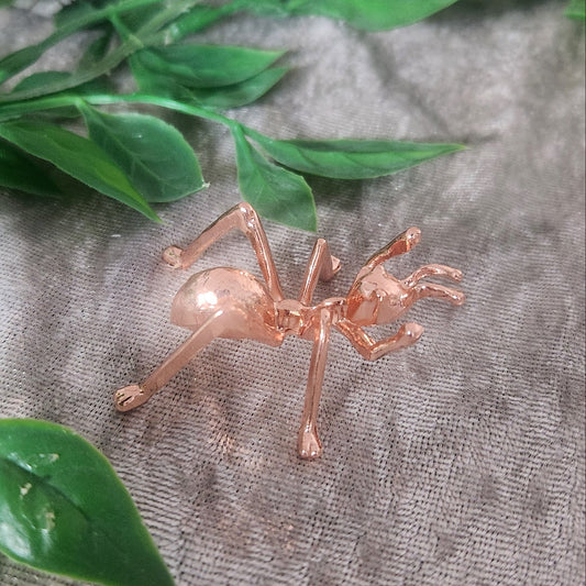 Rose gold ant sphere holder displaying crystal sphere on velvet cloth