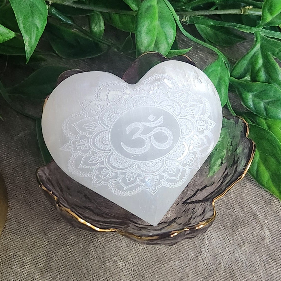 Polished selenite heart crystal with spiritual mandala carving