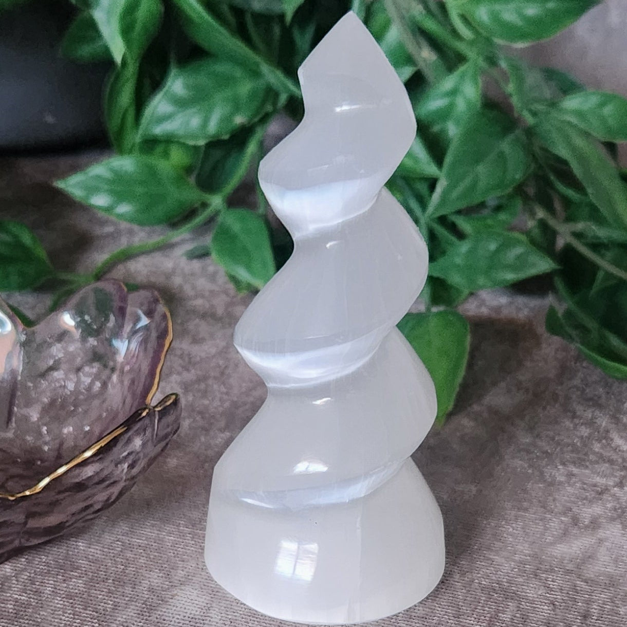 Spiral Satin Spar (Selenite) tower with silky white finish on neutral backdrop