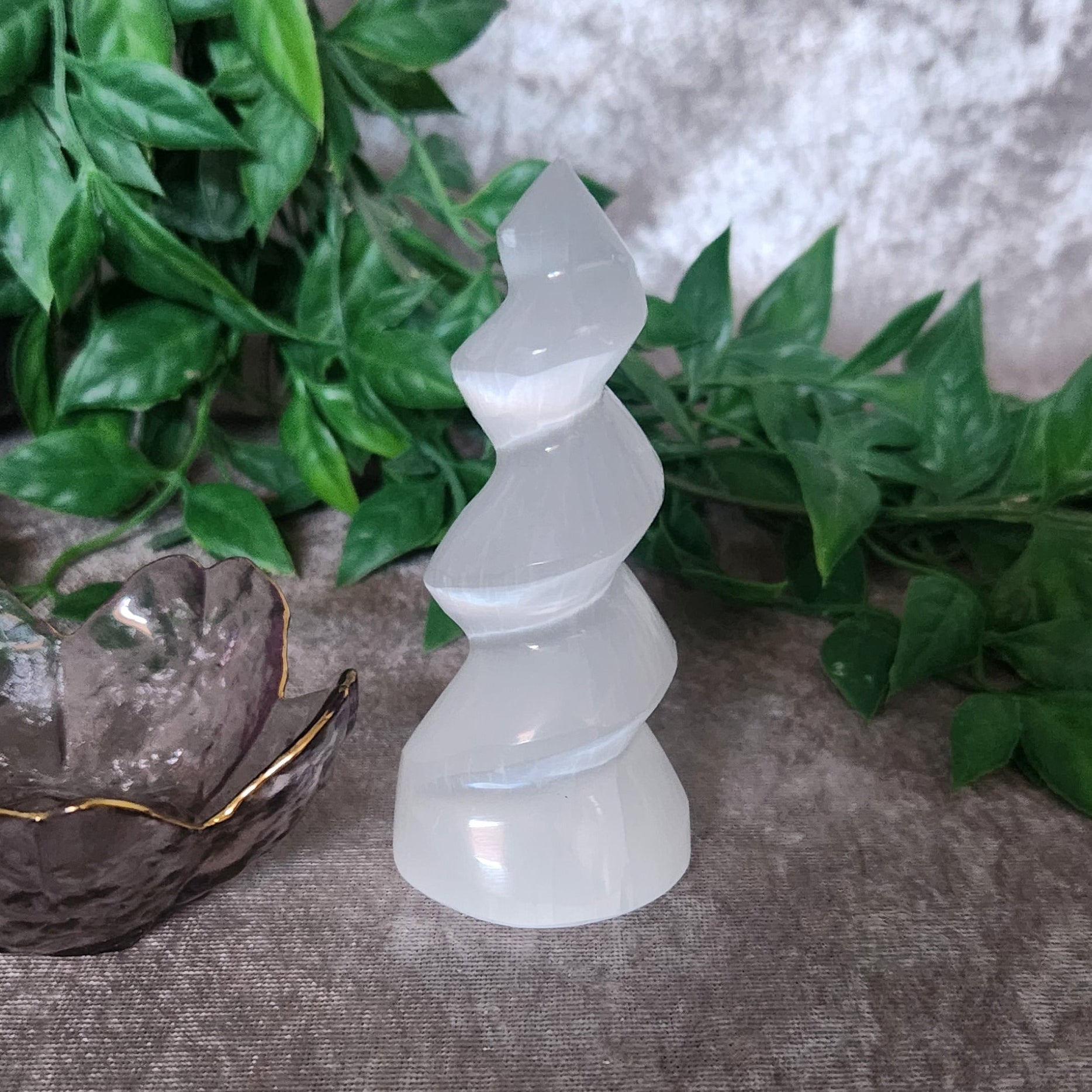 Selenite spiral tower crystal displayed as altar and meditation decor