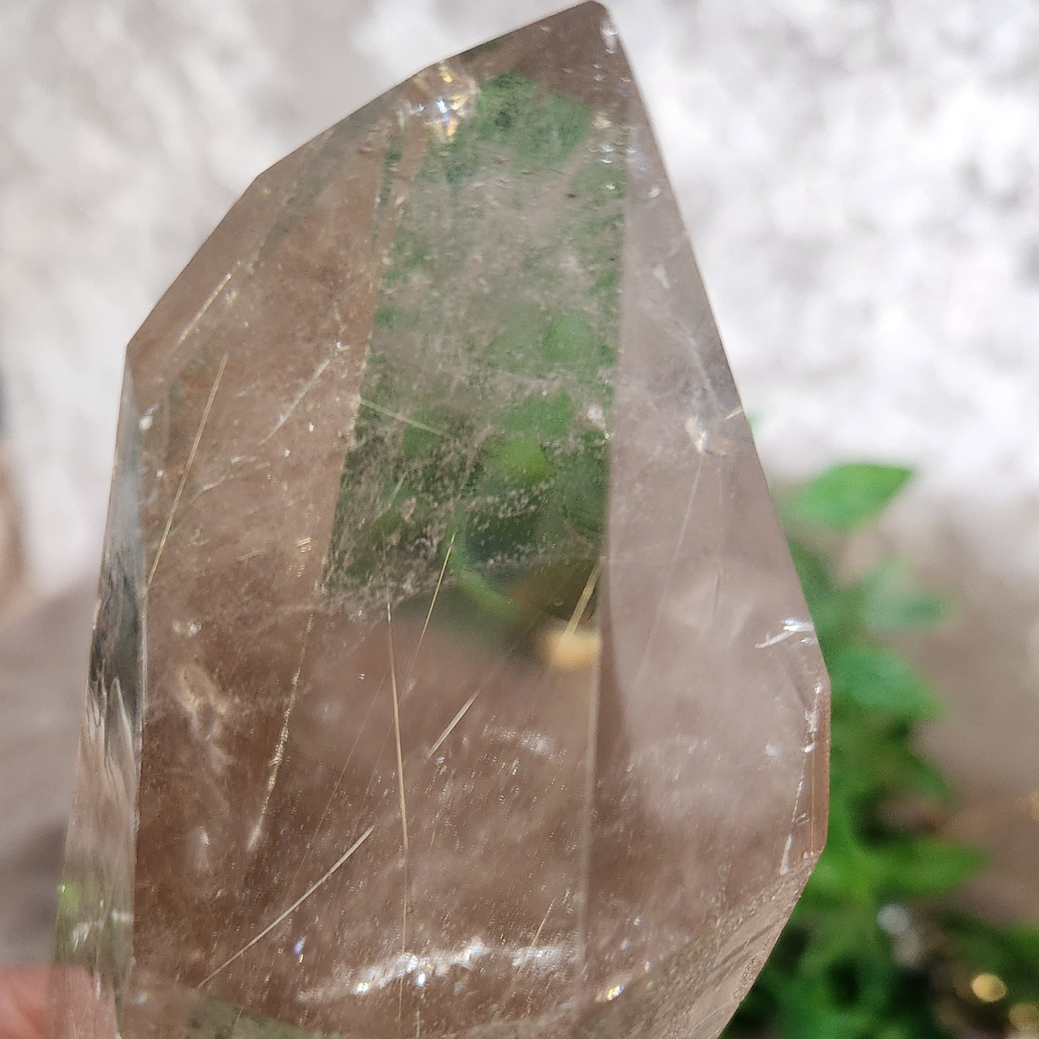 Silver Rutile Clear quartz point mounted on stand highlighting natural crystal structure