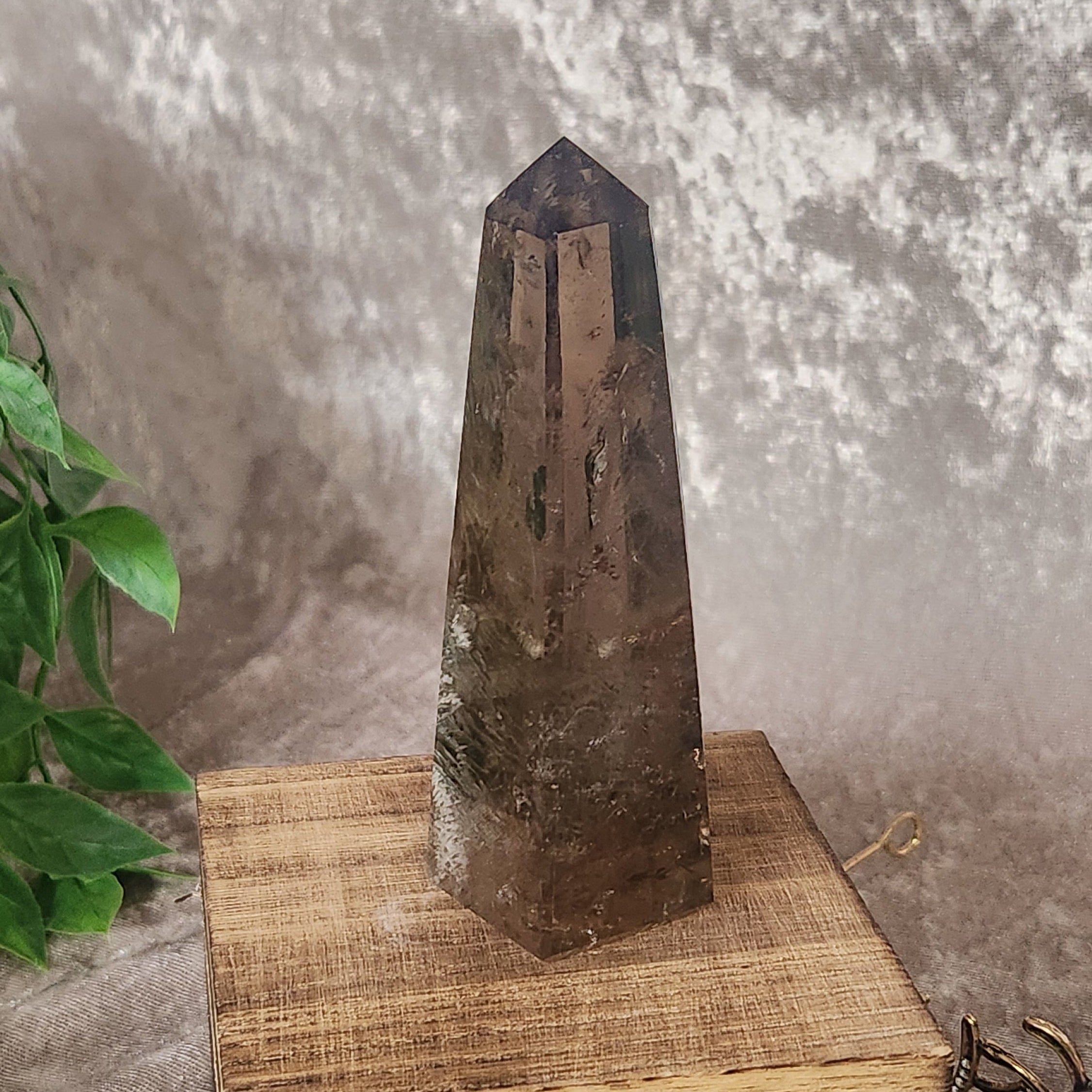 Smoky Quartz crystal tower photographed on wooden display block