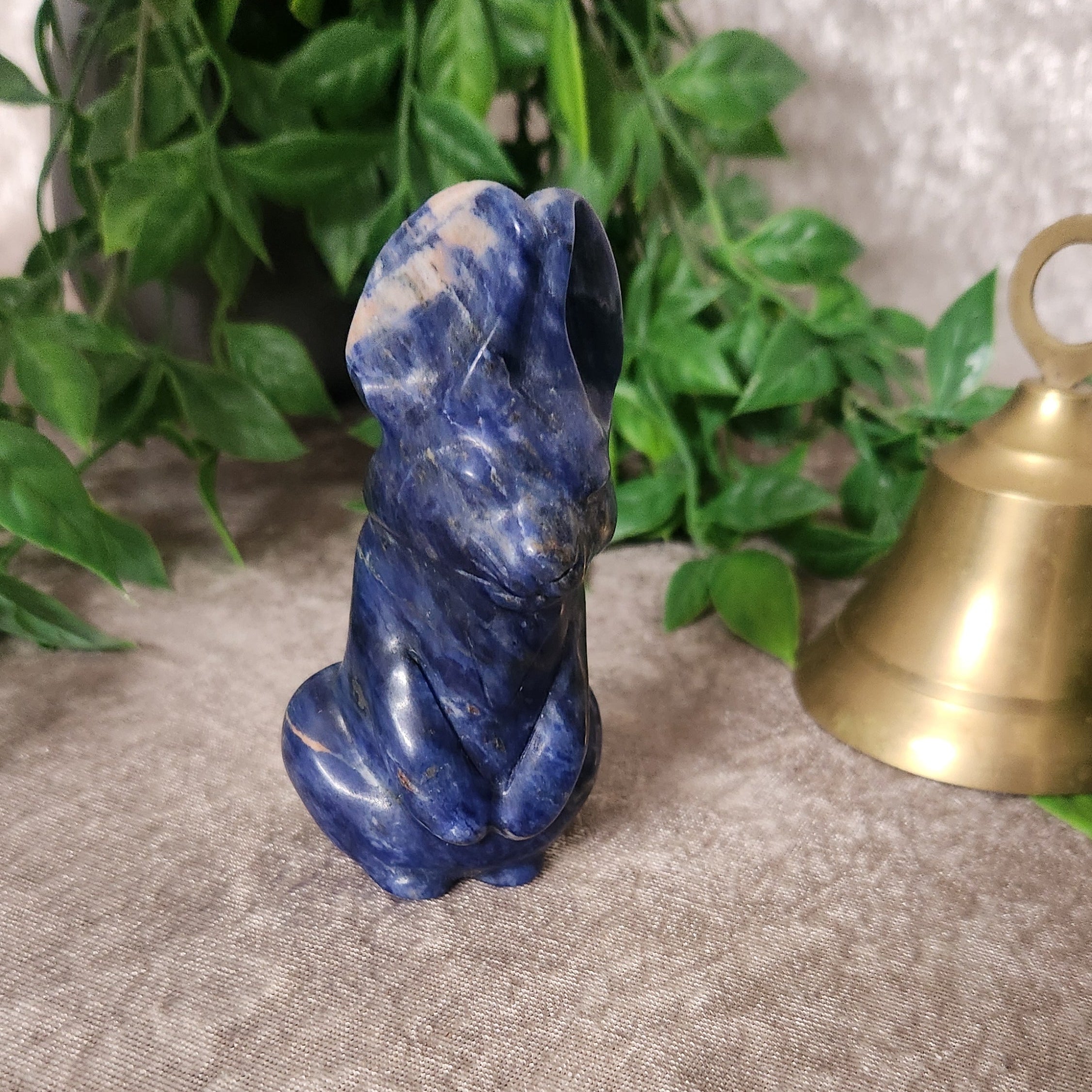 Small hand-carved crystal bunny figurine symbolising luck, joy and playful energy