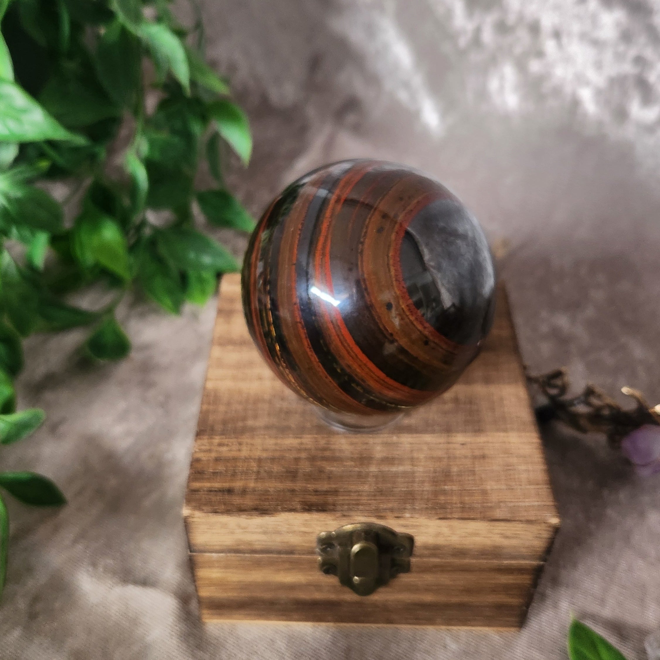 Tiger Iron crystal sphere showing layered tiger’s eye, hematite, and jasper patterns