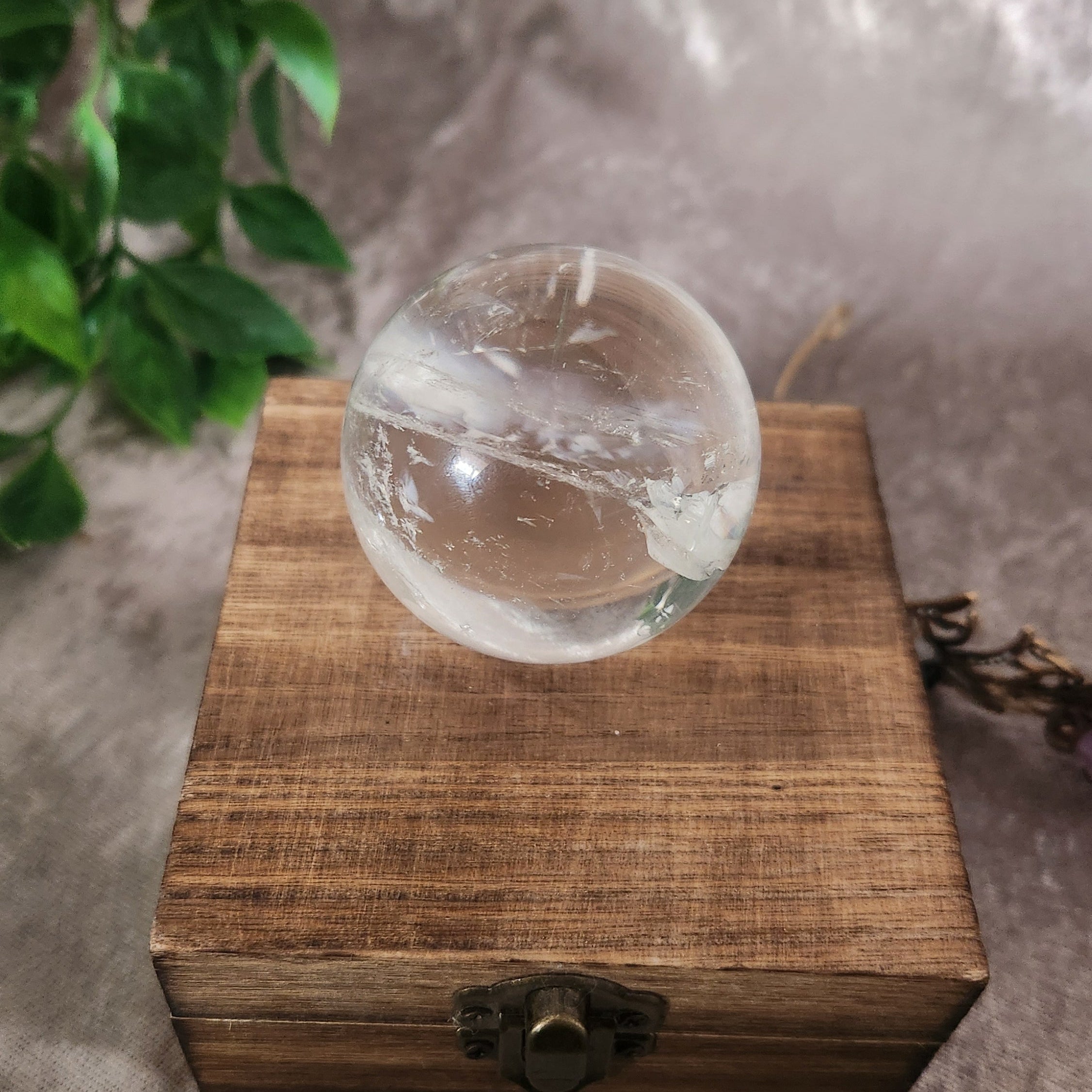 Clear quartz sphere displaying natural crystal formation details