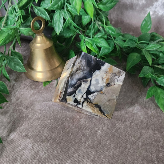 Polished volcano agate cube showing natural layers and grounding tones