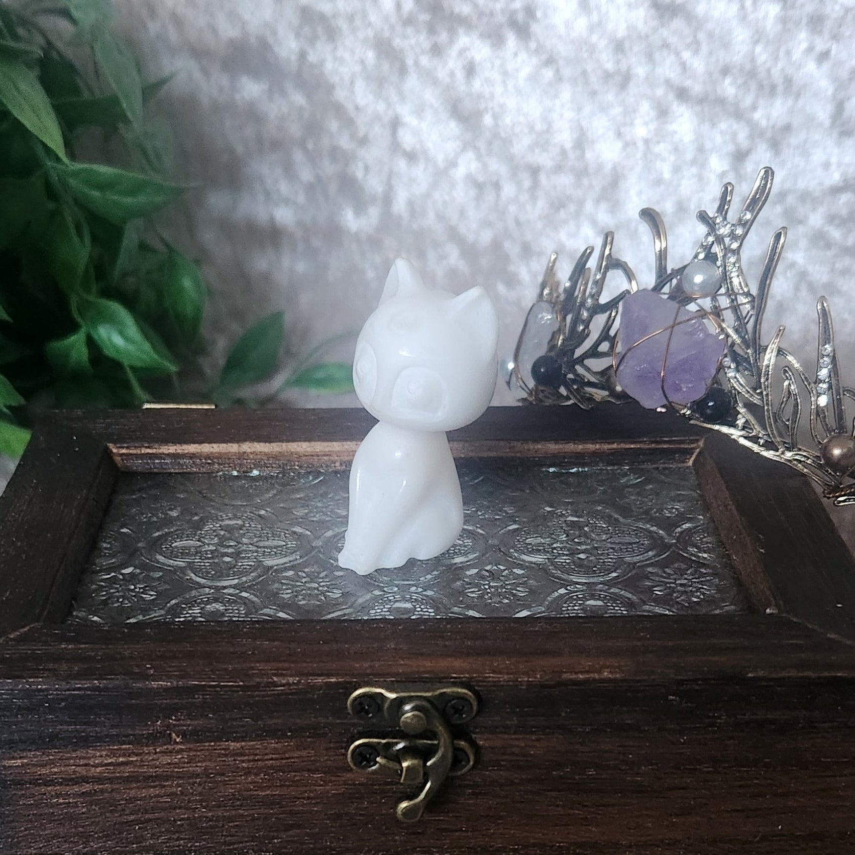 White Jade Cat sitting proudly on boho style box with witchy tiara leaning on the box