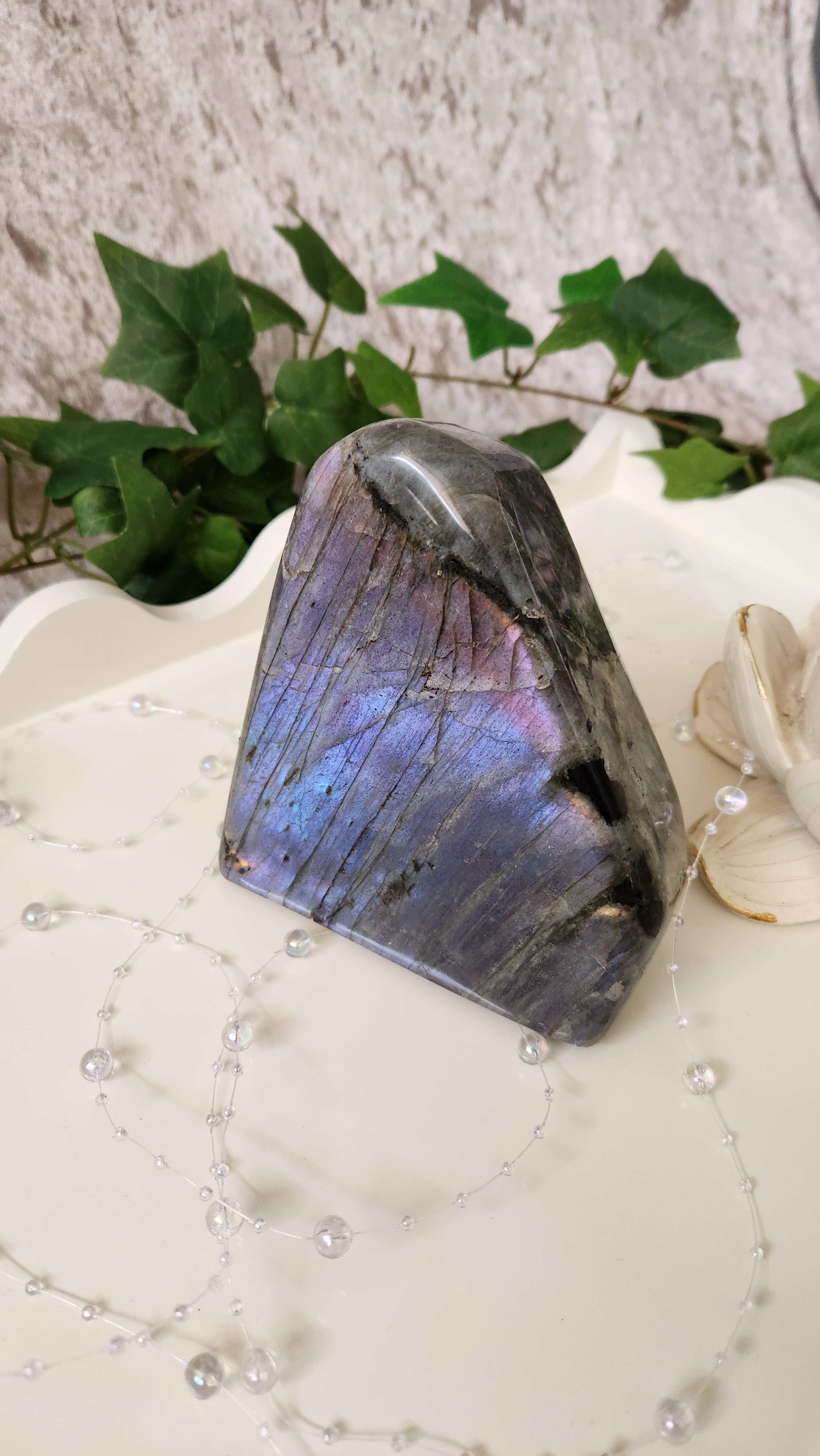 Labradorite freeform with vivid flashes of blue and green on soft backdrop