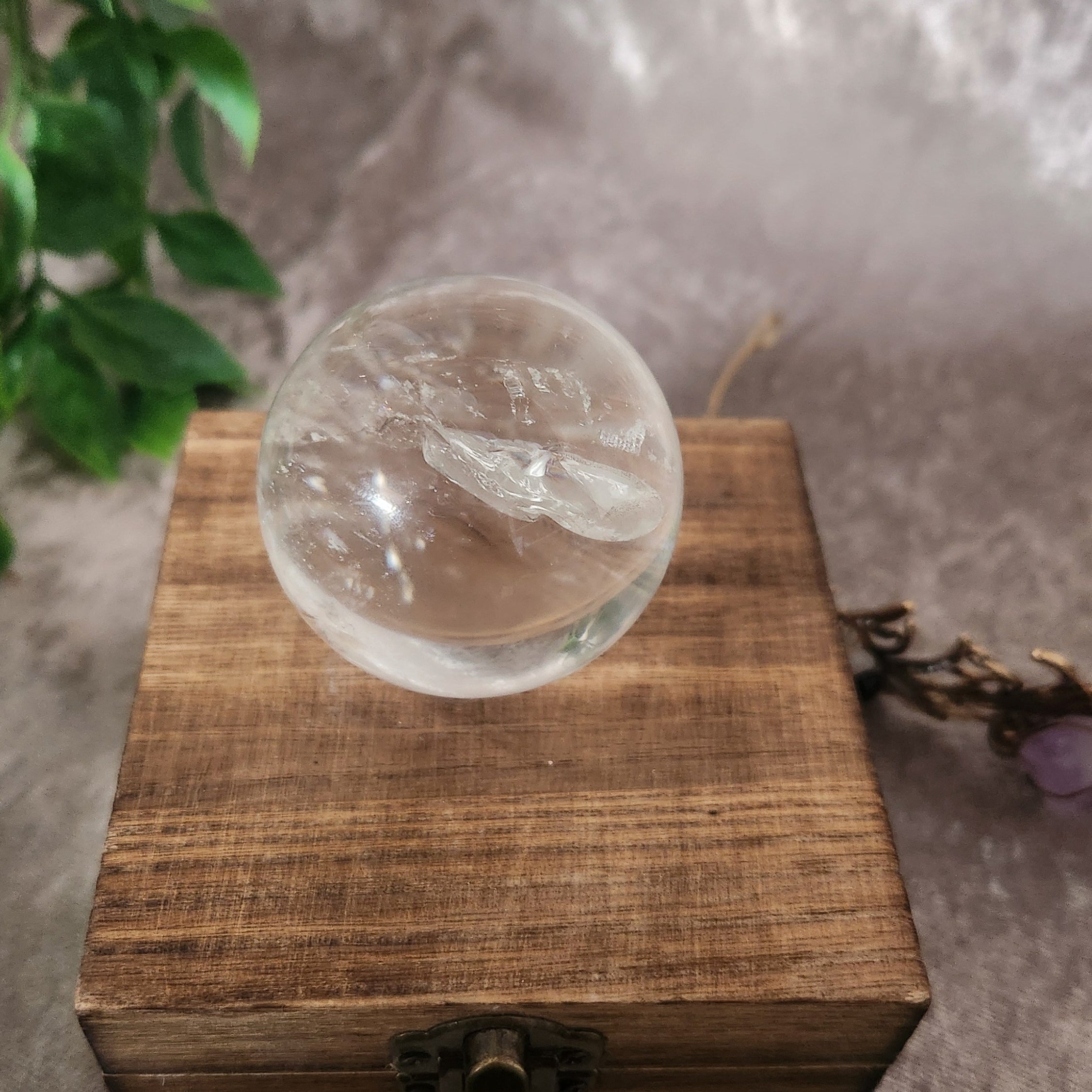 High-clarity clear quartz crystal sphere viewed from front angle