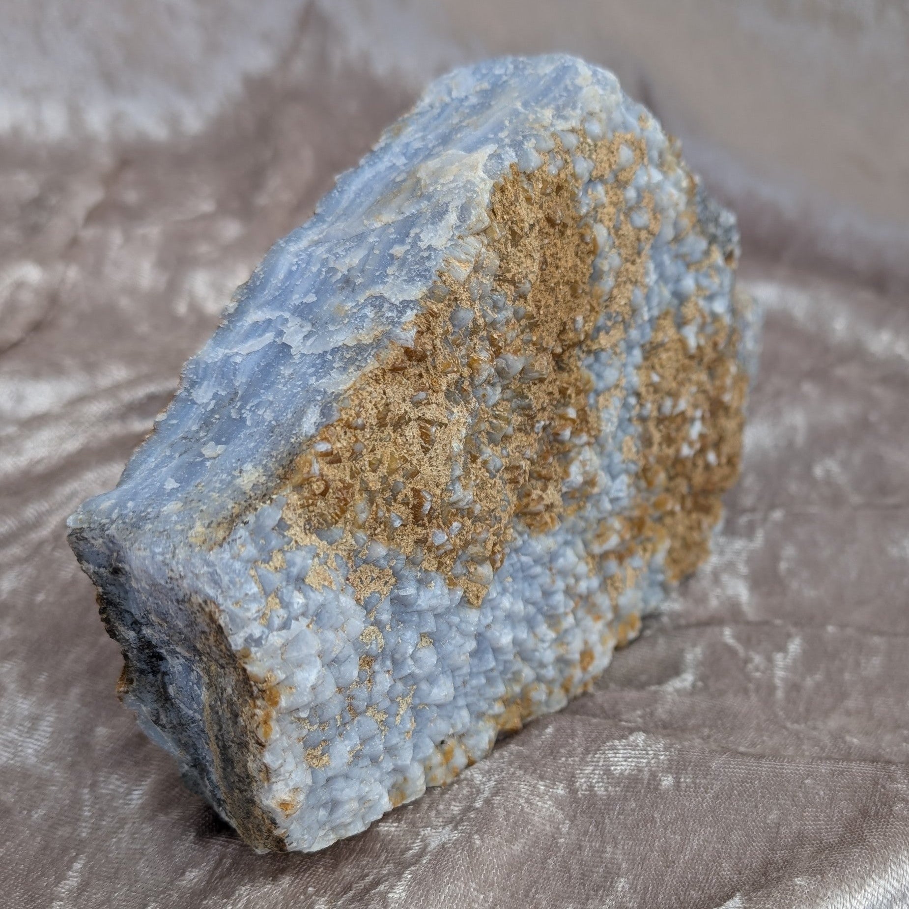 Close up of raw blue lace agate highlighting layered blue patterns