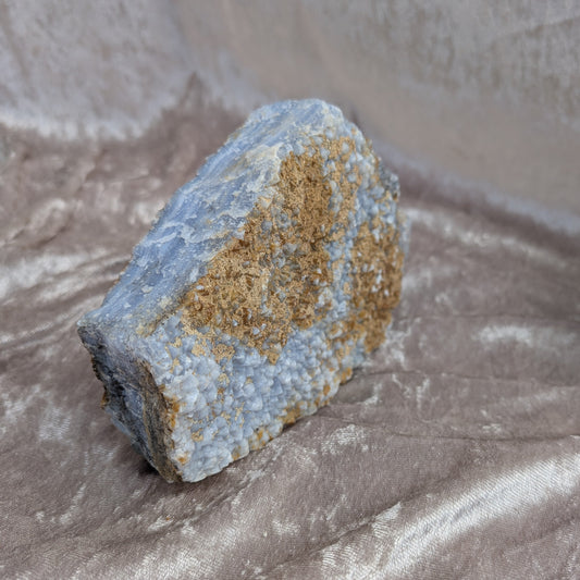 Raw blue lace agate specimen with natural banding and textured surface