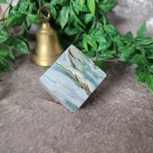 Sea jasper cube with soft blue and white banded patterns