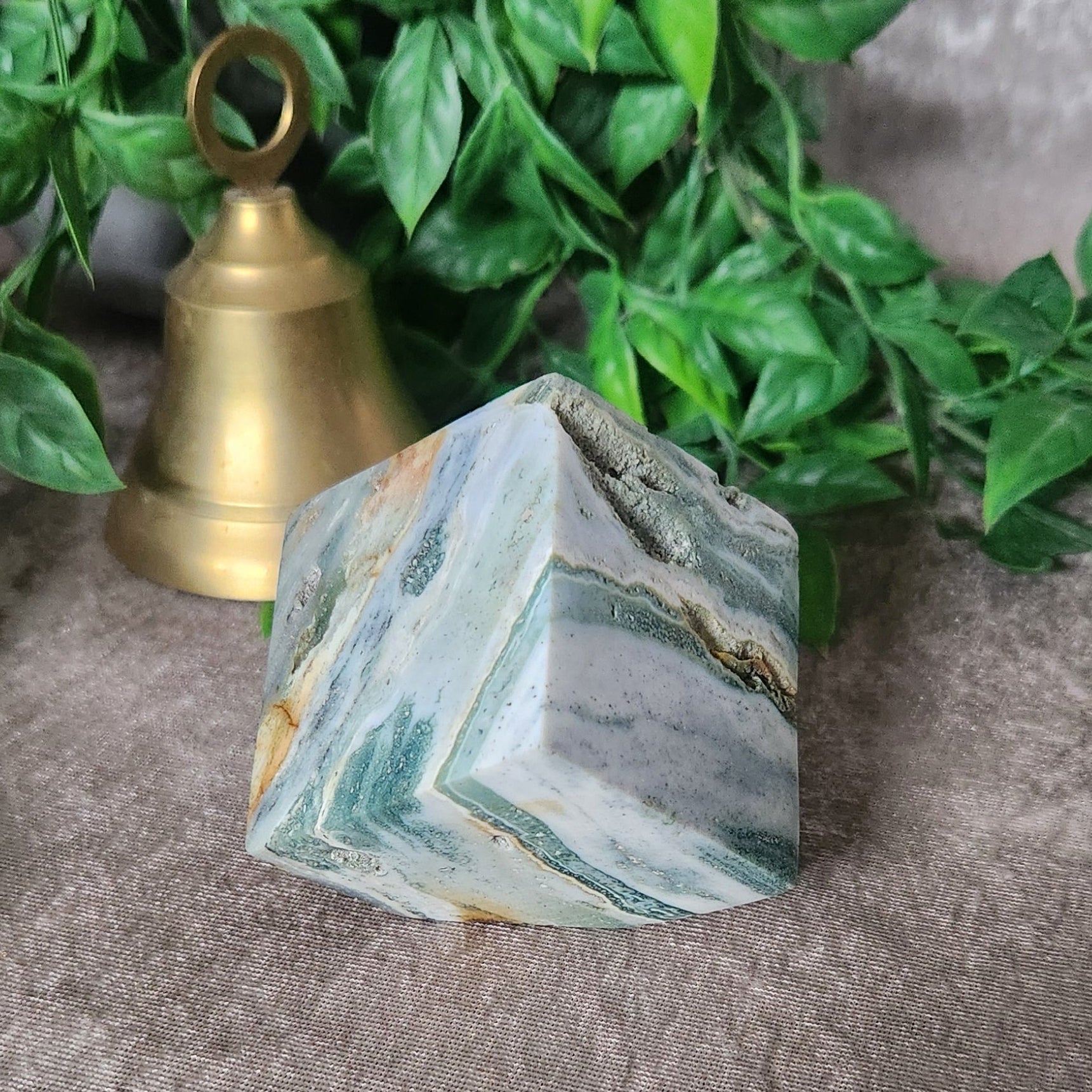 Natural sea jasper cube with flowing layered stone patterns