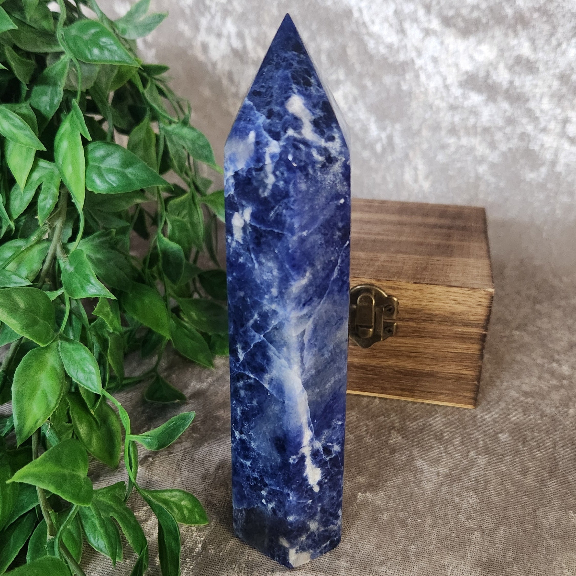 Natural sodalite tower with rich indigo tones and calcite inclusions