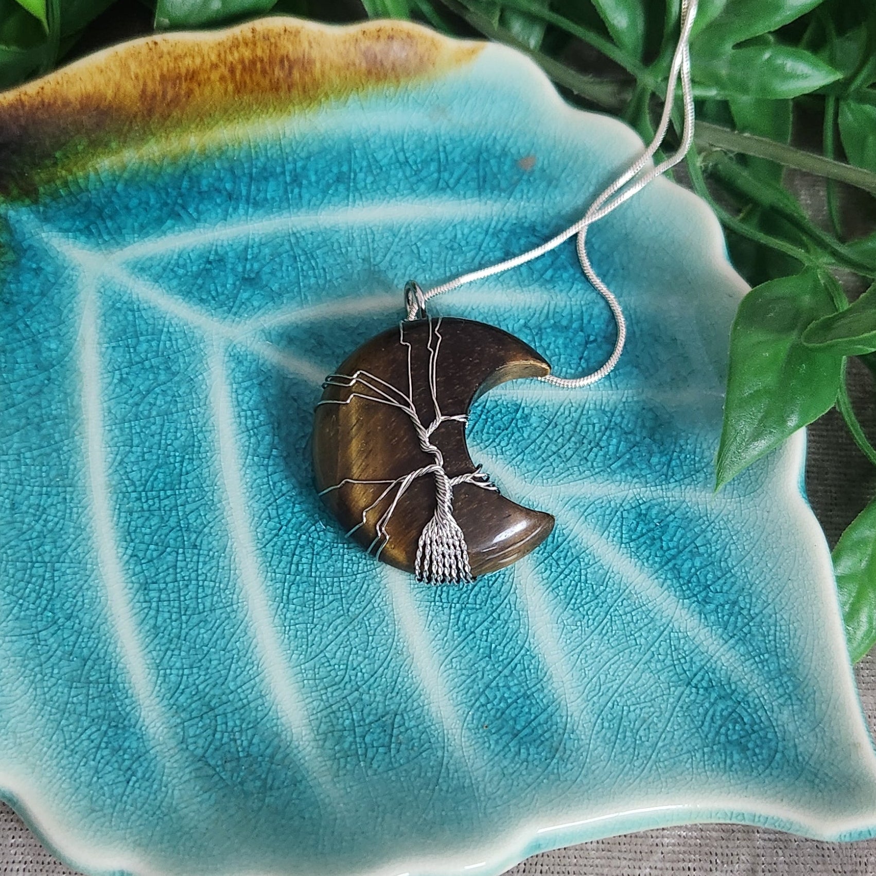 Polished tiger eye crescent moon pendant with chain included